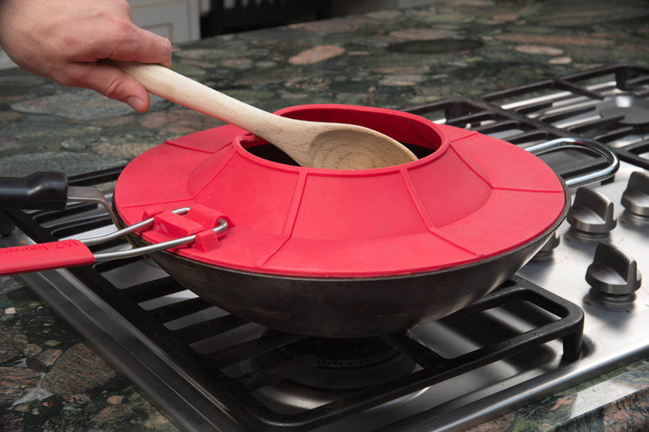 Splatter guard screen being used on a bar-b-que grill stove