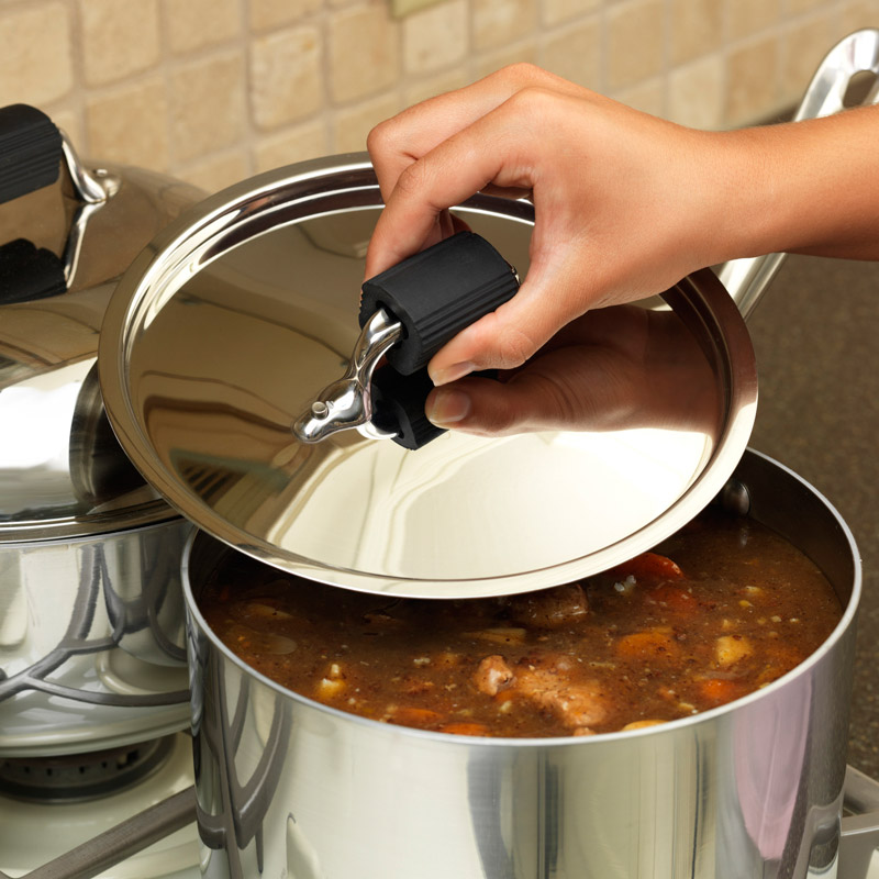 Hand picking up pot lid with Cool Touch™ Pot Lid Handle Cover