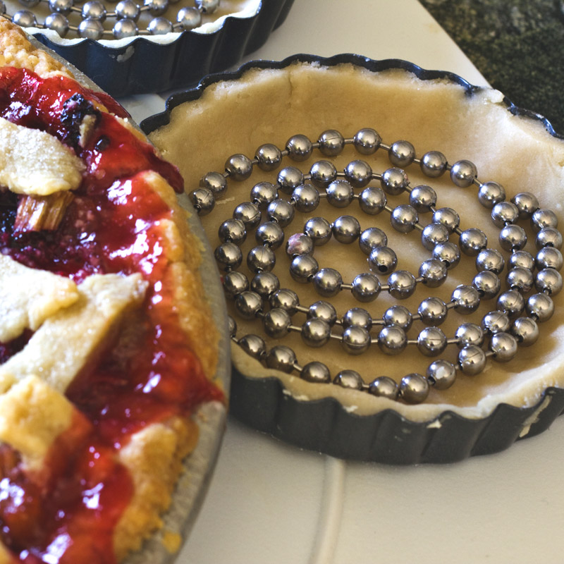 Pie weight chain baking beads in bottom of pie pan