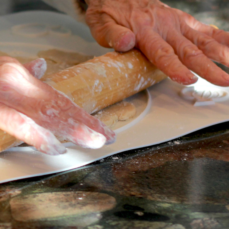 Woman rolling pie dough With Perfect Crust™ Pastry Pie Mat