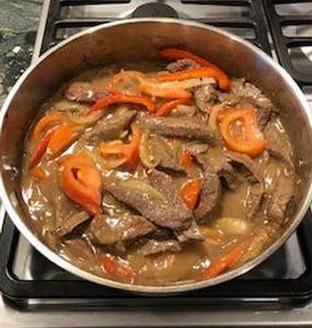steak and peppers cooking