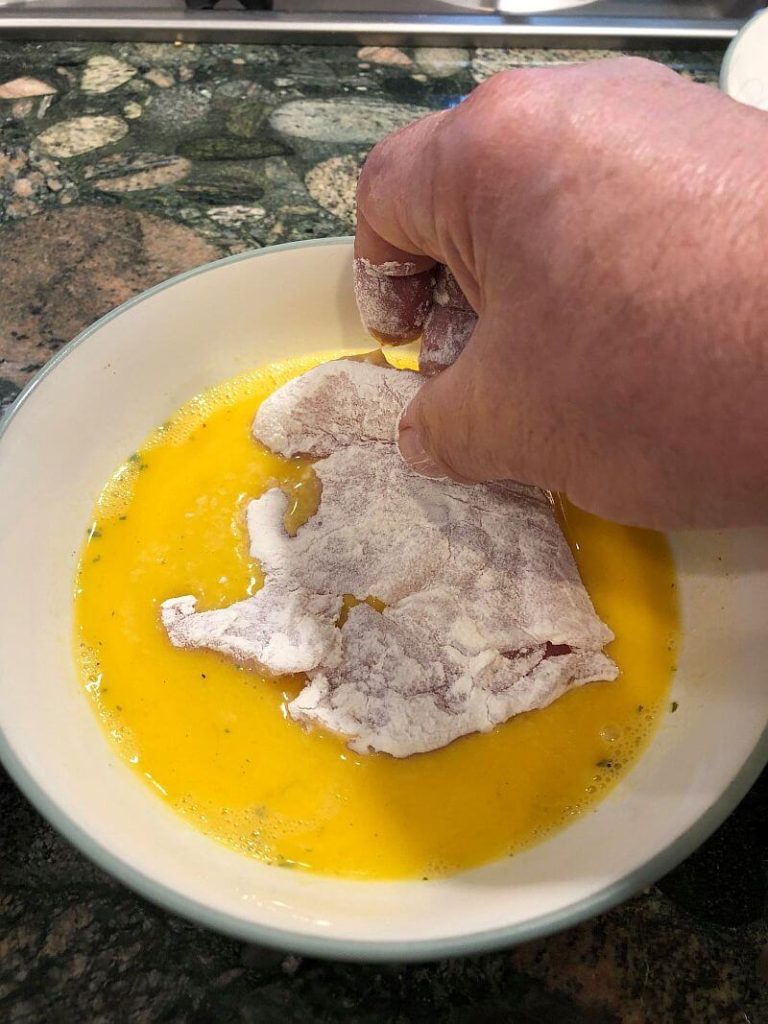 floured chicken in egg