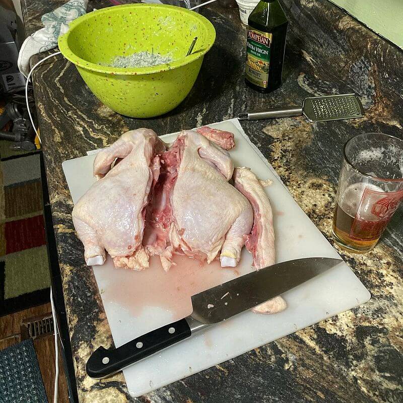 Raw chicken cut up on cutting board